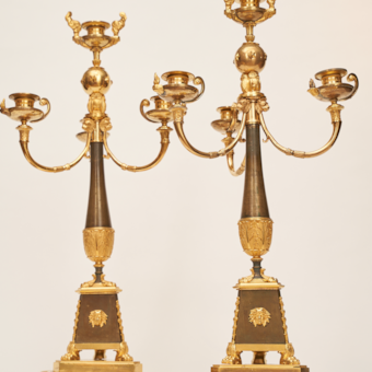 A Pair of Candlesticks of Gilded Bronze