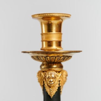 A Pair of Candleholders of Gilded and Patinated Bronze