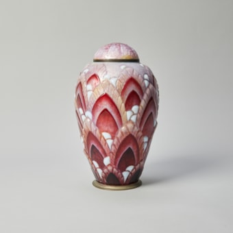 Enamelled copper vase with stylised foliage pattern in shades of red and white