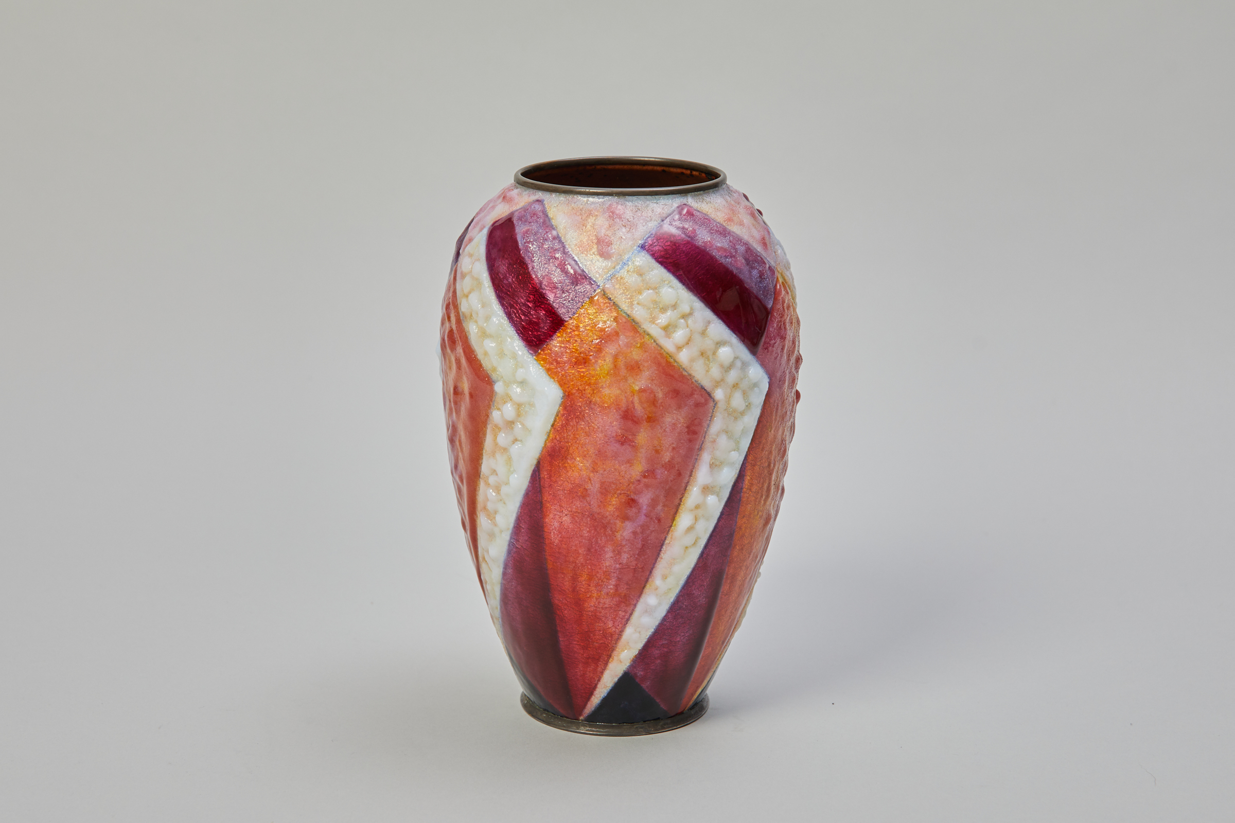 Enamelled copper vase. Camille Faur&eacute;&nbsp;<br />
(Limoges 1874 - 1956)&nbsp;<br />
<br />
Enamelled copper vase<br />
<br />
Limoges, circa 1930<br />
<br />
Geometric pattern in shades of red and white<br />
<br />
Signed: C. FAUR&Eacute; Limoges France&nbsp;<br />
<br />
&nbsp; | Ralph Gierhards Antiques & Fine